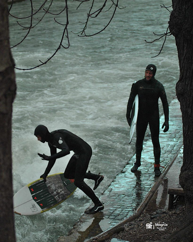 Surfers are seen here all year round riding on the huge waves in this small stream in the English Garden. Eisbachwelle, Munich.