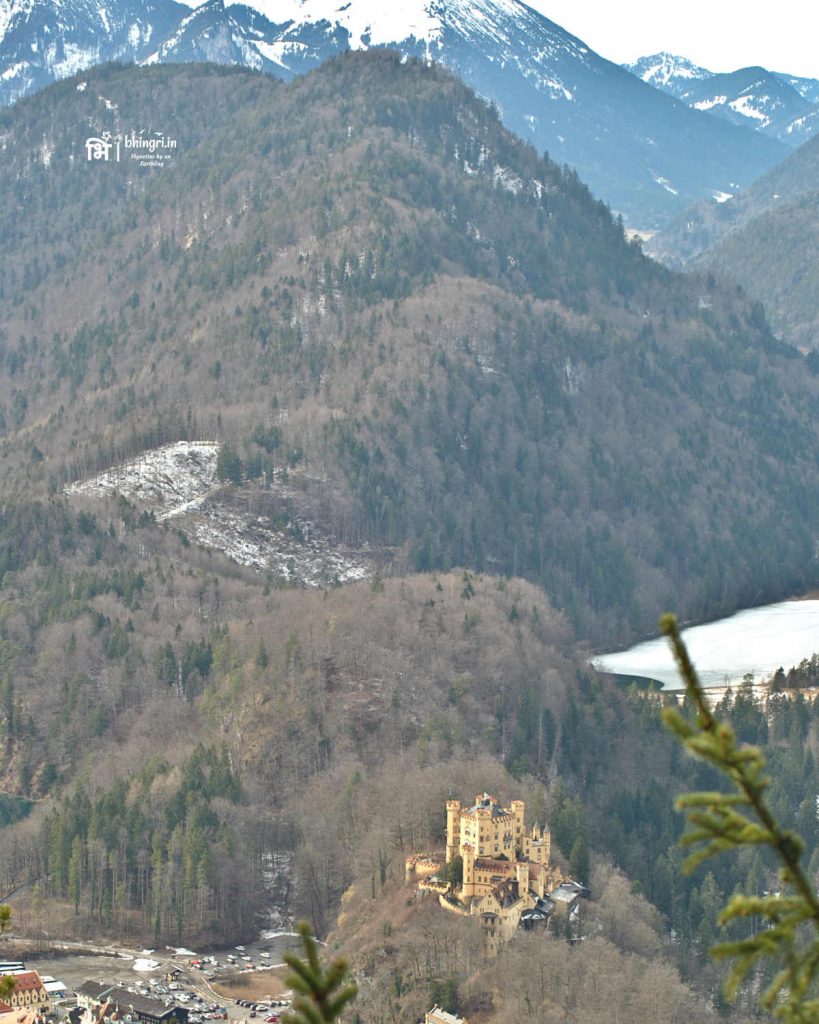 View of the Hohenschwangau Castle from Neuschwanstein with the backdrop of snowy Alps